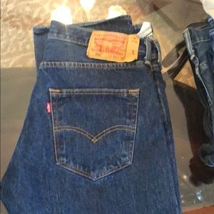 One park of dark washed Levi jeans.